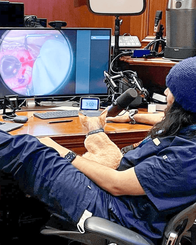 Dr. Ike Ahmed in his house with his cat mentoring Dr. Ticiana de Francesco in a challenging surgery. He was in Canada and she was in Brazil through MicroREC and Zoom.